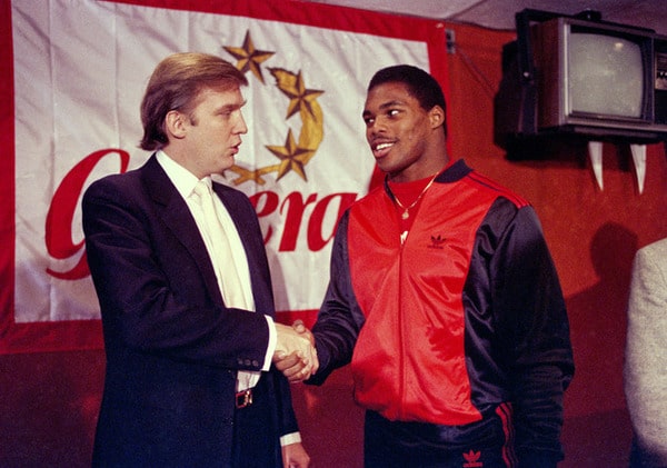 FILE - In this March 8, 1984, file photo, Donald Trump shakes hands with Herschel Walker in New York after agreement on a 4-year contract with the New Jersey Generals USFL football team. The New Jersey Generals have been largely forgotten, but Trumps ownership of the team was formative in his evolution as a public figure and peerless self-publicist. With money and swagger, he led a shaky and relatively low-budget spring football league, the USFL, into a showdown with the NFL. (AP Photo/Dave Pickoff, File)
